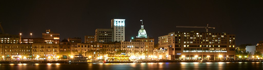 Downtown Savannah at night, with the river in the foreground